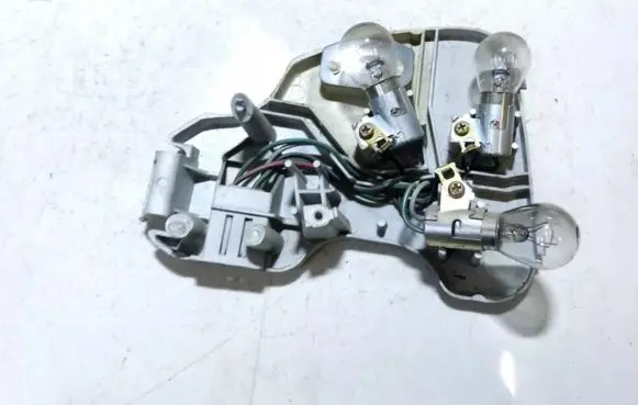 Tail light bulb cover holder