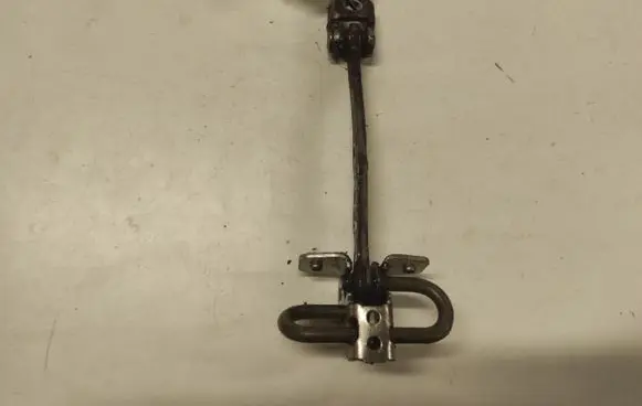 Front door check strap stopper
