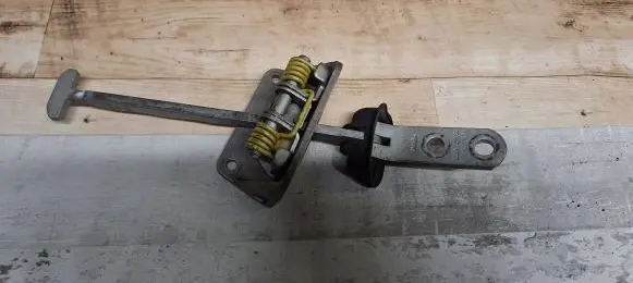 Front door check strap stopper