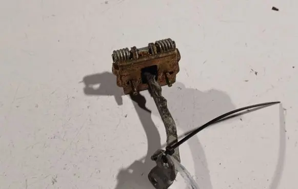 Front door check strap stopper