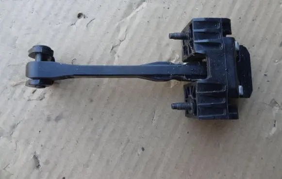 Front door check strap stopper
