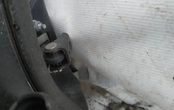 Front door check strap stopper