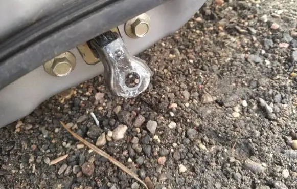 Front door check strap stopper