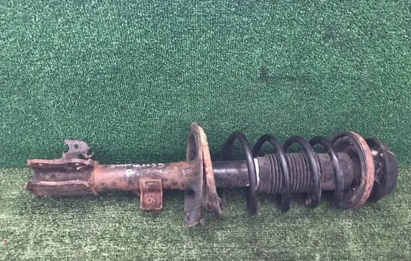 Suzuki Swift I Front shock absorber with coil spring
