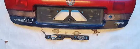 Mazda 626 Trunk door license plate light bar 043-1394