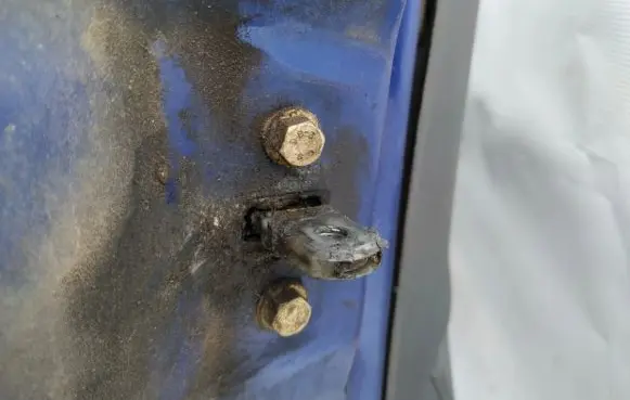 Front door check strap stopper