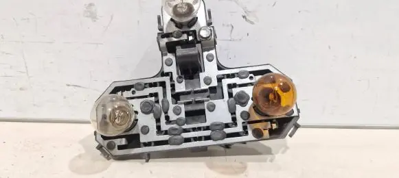 Tail light bulb cover holder