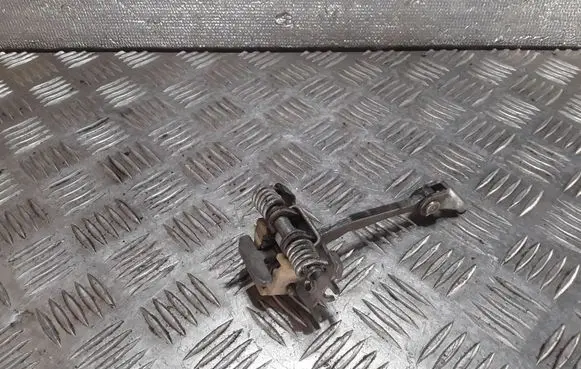 Front door check strap stopper