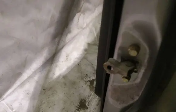 Front door check strap stopper