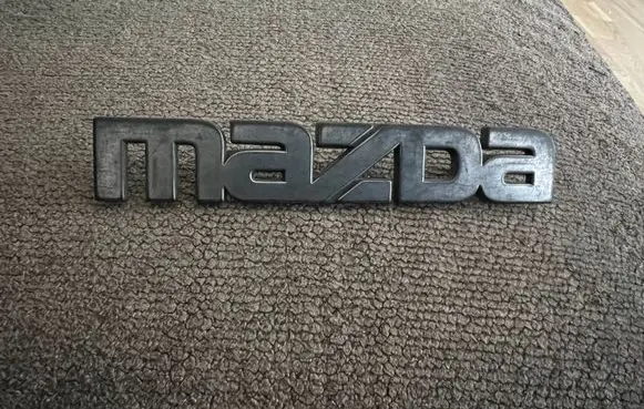 Mazda 323 Manufacturers badge/model letters 