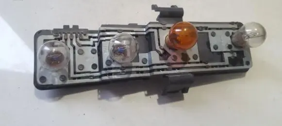 Tail light bulb cover holder