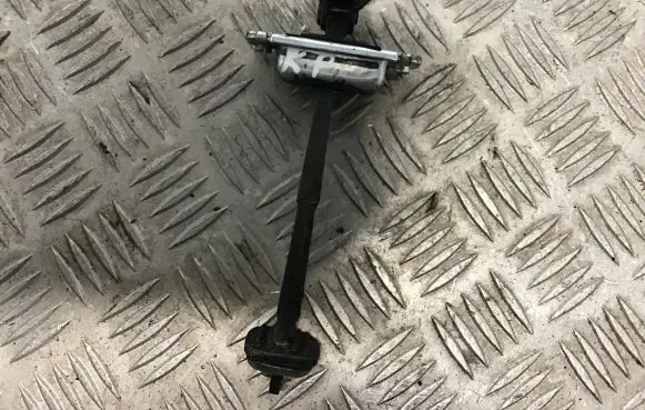 Front door check strap stopper