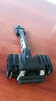 Front door check strap stopper