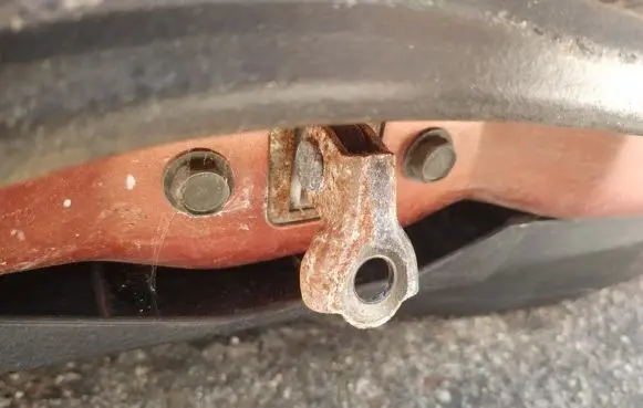 Front door check strap stopper