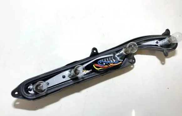 Tail light bulb cover holder