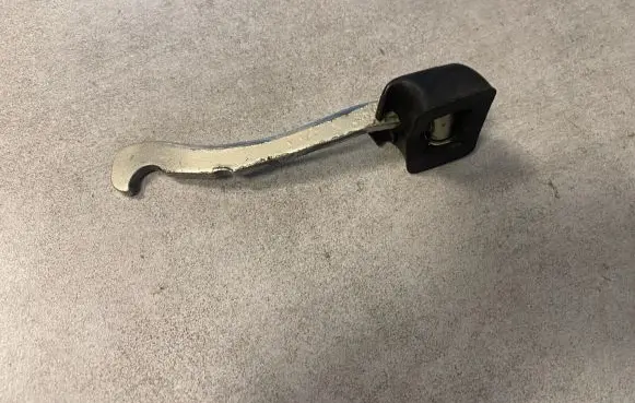 Front door check strap stopper