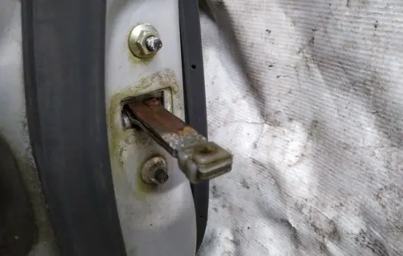 Front door check strap stopper