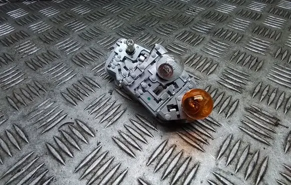 Tail light bulb cover holder
