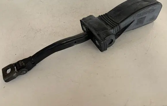 Front door check strap stopper