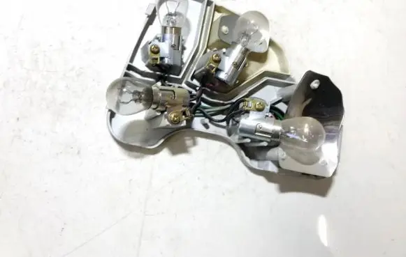 Tail light bulb cover holder